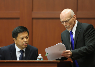 Don West, right, questioning Dr. Shiping Bao (Getty Images)